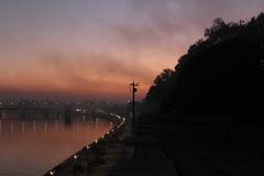 Scenic view of a riverfront with trees and buildings