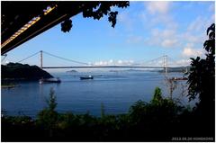 Lantau Link bridge over a body of water on a clear day