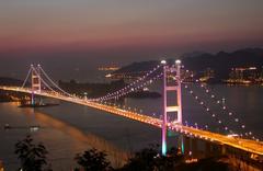 Tsing Ma Bridge lit up at night with colorful lights