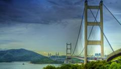 bridge in Hong Kong with city skyline in the background