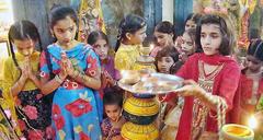 Hindu community children participating in religious rituals during Dewali festival at a temple in Hyderabad