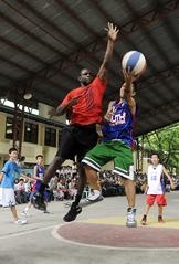 U.S. Navy Intelligence Specialist blocking a shot in basketball game