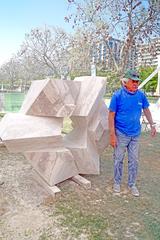 artist sculpting a stone in Parque de las Esculturas during the 6th International Symposium of Sculpture Group