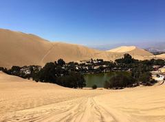 Laguna De Huacachina oasis surrounded by desert dunes