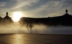 Place de la Bourse at sunset with fog and two girls in Bordeaux