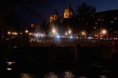 St. Lukas Church in Munich at night with Kabelsteg bridge in the foreground