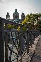 Kabelsteg bridge railings with St. Lukas church in the background in Munich