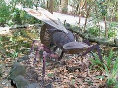 Iron sculpture of a flying ant at La Concepción Botanical Garden in Málaga, Spain