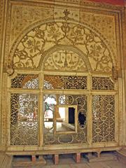 Inlaid white marble screen in imperial residence showcasing crescent moon and stars design.