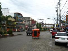 street view along Montilla Boulevard with buildings and trees lining the road