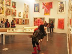 woman reciting poem in front of Bud Shark exhibition at Denver Museum of Contemporary Art