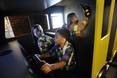 Child driving a fire truck simulator at Glazer Children's Museum