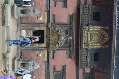 a monument in Nepal with an artistic golden door and window