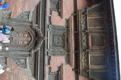 monument in Nepal with intricate wood carving on windows and door