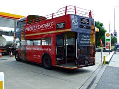 London Bus Experience bus on city street with a clear blue sky