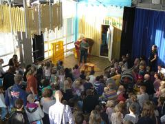 Children's performance with colorful costumes and stage decorations