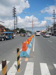 Town of Lemery in Batangas with landmark buildings and vehicles on the road