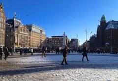 Dam Square in Amsterdam with iconic buildings and a bustling atmosphere