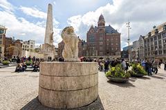 Dam Square in Amsterdam with people walking and historical buildings