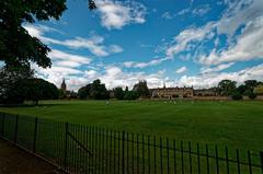 Oxford's historic Christ Church Meadow, showcasing Merton Field with Christ Church Cathedral, Grove Building, and Merton College Chapel.