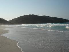 Scenic view of Arraial do Cabo with clear blue waters and lush green hills