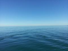 view of a coastal landscape with various shades of blue