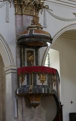 Interior of Basilique Notre-Dame in Fribourg featuring ornate Kanzel pulpit