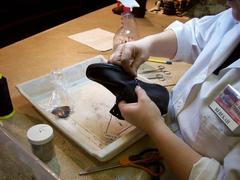 Re-stitching a shoe at Arabia Steamboat Museum