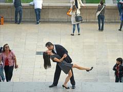 young Asian couple taking photos at Palais de Chaillot with Eiffel Tower in the background