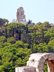 Scenic view of the Parthenon atop the Acropolis in Athens, Greece, with a blue sky background