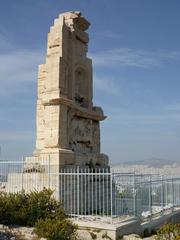 Monument on Filopappos Hill under a blue sky