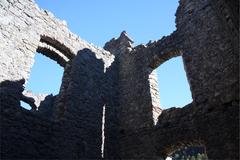 Interior of Castel Belfort with stone walls and arches in Spormaggiore, Italy