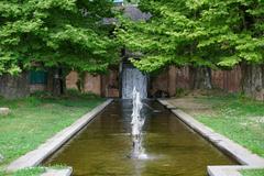 Nishat Bagh terraced Mughal garden with cascading water features and chinar trees near Dal Lake in Srinagar