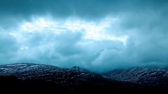 Snowy mountains with clouds in the sky