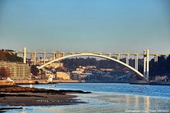 Arrábida Bridge spanning across the Douro River in Porto, Portugal