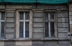 historic German advertisements on a tenement facade at 12 Nehringa Street in Wroclaw