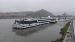 Amadeus ship at International 7 pier with Hotel Gellért, Gellért Hill, and Liberty Bridge in the background, Budapest