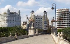 Pont de la Mar stone bridge over artificial water and palm park in Valencia, Spain