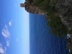 Mallorca coastline view of clear blue sea, rocky shore, and a sunny sky