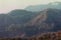 aerial view of the Hollywood sign on the hills with Los Angeles cityscape in the background