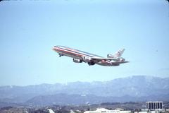 American Airlines DC-10 taking off from LAX with Hollywood sign in the distance