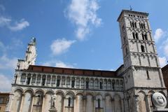 Aerial view of historic Lucca, Italy, featuring medieval architecture and surrounding walls.