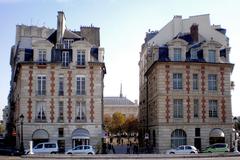 Place Dauphine in Paris with people walking and outdoor seating