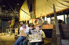 Family exploring maritime history museum exhibit