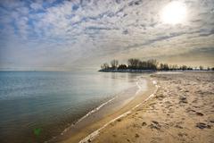 footprints in the sand on a snowy Woodbine Beach shoreline