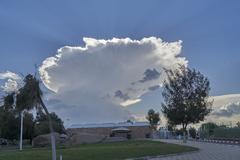 Sun behind a cumulonimbus incus cloud