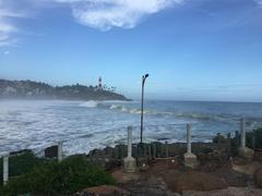 Kovalam Lighthouse with rainy clouds and high waves