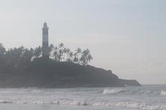 Vizhinjam Lighthouse seen from Kovalam Beach with clear blue sky