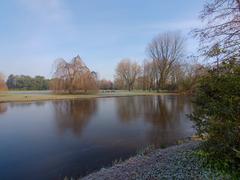 Beatrixpark in the spring with green trees, a calm stream and lush grass