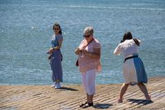 Cais das Colunas at sunset with people by the waterfront, in Lisbon, Portugal